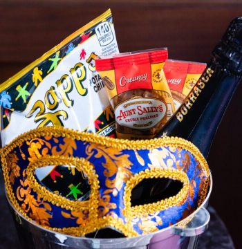 Mardi Gras mask with snacks and champagne.