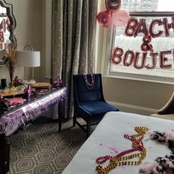 Bachelorette party room with decorations and balloons.