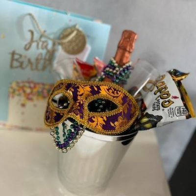 A cup with a mask and some crackers in it