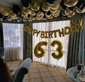 A room with balloons and a table in it