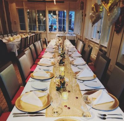 A long table with plates and silverware on it