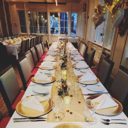 A long table with plates and silverware on it